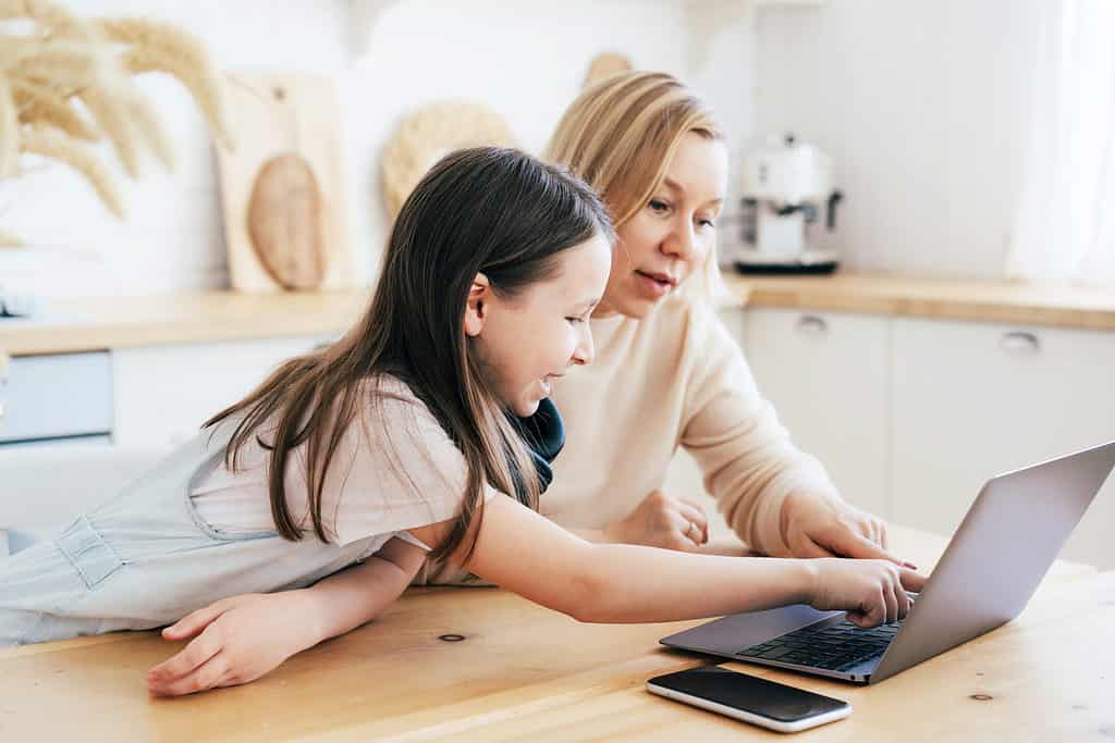 business ideas for kids - woman helping daughter on computer